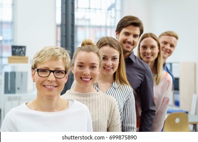 A Happy, Smiling Office Work Team In An Ascending Order Style Portrait In A Bright Office Setting.