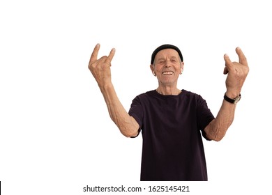 Happy Smiling Old Man In Black T-shirt And Hat, Senior Doing Rock And Roll Gesture, Isolated Over White Background, Studio Photo