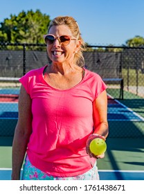 Happy, Smiling Pickleball Player Holding A Ball