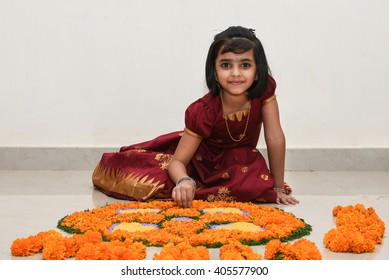 Happy Smiling Playful Young Indian / South Indian Girl Wearing Traditional Dress Holding / Making  Flower Design/ Bed  For Onam, Vishu Kerala India. Beautiful Daughter/ Kid In Indian Sari. Asian Child