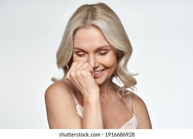 Happy Smiling Pretty Shy 50s Middle Aged Woman Laughing, Cheerful Mature Lady Touching Healthy Soft Face Skin. Anti Age Healthy Skincare Treatment And Cosmetic Ads. Face Close Up View Portrait.