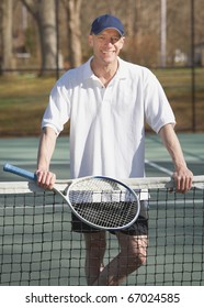 Happy Smiling Pro Tennis Instructor On Court