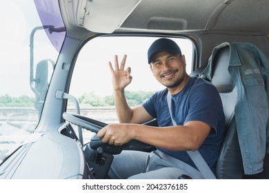 Happy Smiling Proud Confident Asian Young Man Beard Professional Truck Driver In Business Long Transport. Male Owner Small Business Transportation Trucking Driving And Delivering Goods To Warehouse.