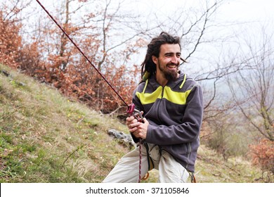 Happy Smiling Rasta Man Belaying On Climbing Trip