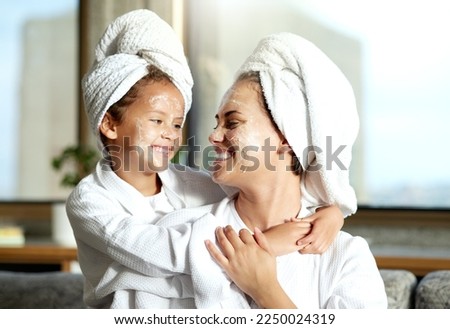 Happy, smiling and relaxed mother and daughter spa day at home with face masks for healthy skincare and personal hygiene. Cute little girl and parent bonding and enjoying a pamper treatment together Stockfoto © 