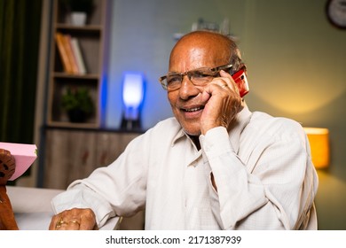 Happy Smiling Senior Old Man Talking On Mobile Phone At Home - Concepts Of Technology, Relaxation And Communication