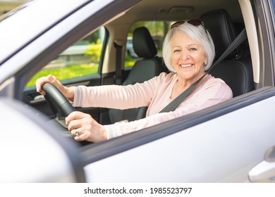 A Happy and smiling senior woman in white car - Powered by Shutterstock