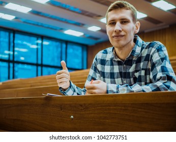 Happy Smiling Student Big Finger In The Empty Big Lecture Hall