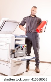 Happy Smiling Technician Man Near Printer Copier With Red Fire E