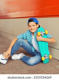 Happy smiling teenager boy with skateboard in casual wear on city street - Shutterstock ID 2319334269