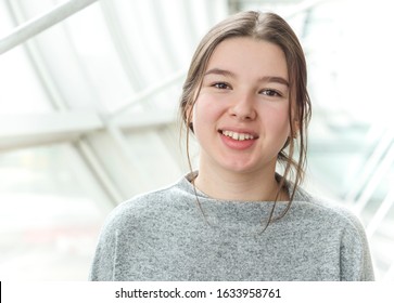Happy smiling teenager girl in bright room portrait
