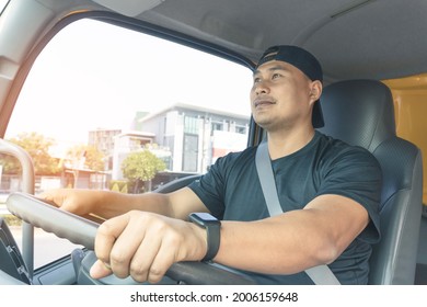 Happy Smiling Truck Driver Bearded Male Fastens His Seat Belt While Driving. Delivery Man Transport With A Semi-truck, Trustworthy, Friendly Service.