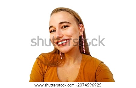 Happy smiling woman with Christmas lollipops. Christmas candy. Isolated on a light background. 
