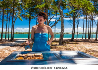 Happy Smiling Woman Cooking Barbeque On The Beach In Australia