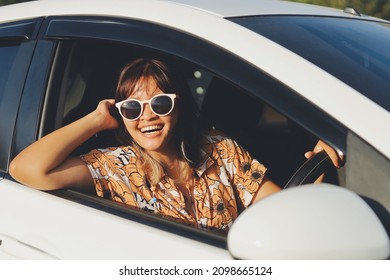 Happy Smiling Woman Driving Her New Car At Sunset.Asian Woman Driving A Car By The Beach.