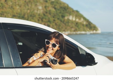 Happy Smiling Woman Driving Her New Car At Sunset.Asian Woman Driving A Car By The Beach.