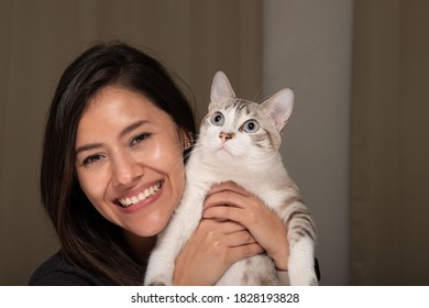 Happy Smiling Woman And Her White Striped Cat Not Looking At The Camera Posing For A Picture