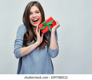 Happy Smiling Woman Holding Small Red Gift Box. Isolated Studio Portrait.