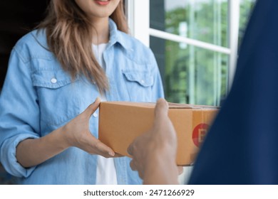 Happy smiling woman receives boxes parcel from courier in front house. Delivery man send deliver express. online shopping, paper containers, takeaway, postman, delivery service, packages - Powered by Shutterstock