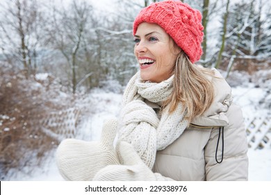 Happy Smiling Woman Standing In Winter Clothing Outdoors In The Snow