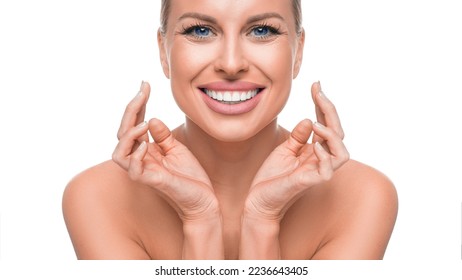 Happy smiling woman touching her face. Anti-age skin cate and tooth whitening concept.