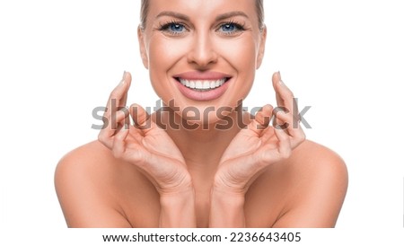 Happy smiling woman touching her face. Anti-age skin cate and tooth whitening concept.