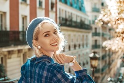 Happy, Smiling Woman Wearing Stylish Autumn Blue Checkered Dress, Beret, Pearl Earrings, White Wrist Watch, Posing In Street Of Paris. Copy, Empty Space For Text