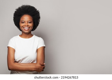 Happy smiling woman wearing white empty t-shirt standing on white background - Shutterstock ID 2194267813