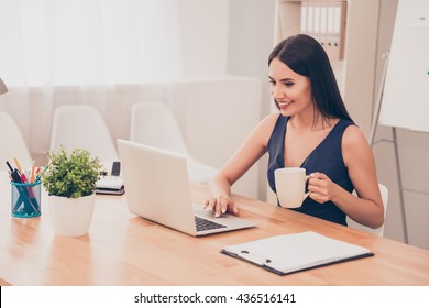 Happy Smiling Woman Working With Laptop And Drinking Coffee