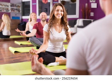 Happy Smiling Young Adults Having Yoga Class In Sport Club