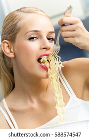 Happy Smiling Young Blond Woman Eating Spaghetti Indoors