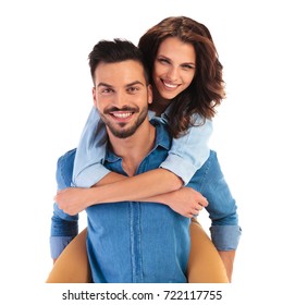 Happy Smiling Young Casual Couple On White Background, Woman On The Back Of Her Boyfriend