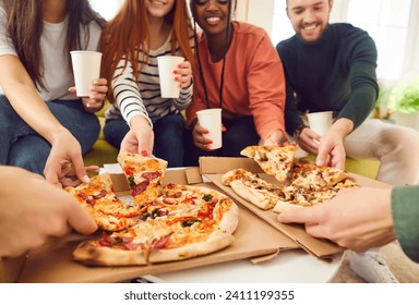 Happy smiling young people friends gathering in pizzeria or at home together eating tasty Italian food taking pizza slices from box enjoying party with cardboard cups in hands. Food delivery concept. - Powered by Shutterstock