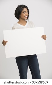 Happy Smiling Young Woman Holding A Blank Billboard White Background