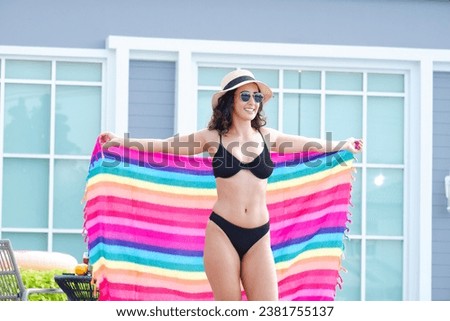 Similar – Brunette surfer woman in bikini standing with surfboard