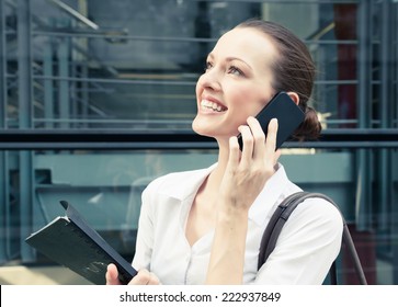Happy smiling young woman talking on mobile phone - Shutterstock ID 222937849