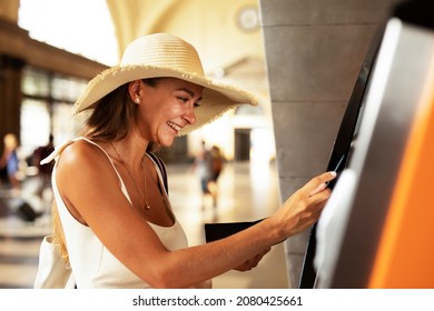 Happy Smiling Young Woman Withdrawing Money From Credit Card. Young Woman Using ATM Mashine	