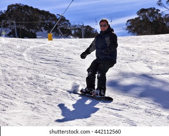 Happy Snowboarder Slides Down The Track In Snowy Mountains Ski Resort Of Perisher Valley, Kosciuszko National Park.