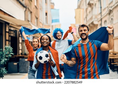 Happy Soccer Fans Celebrating Victory Of Their Team While Walking On The Street.