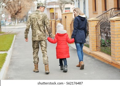 Happy soldier with family outdoors - Powered by Shutterstock