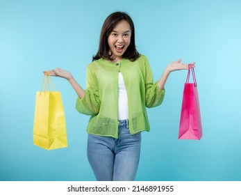 A Happy South East Asian (Indonesian) Girl Holding Shopping Bags In A Isolated Background