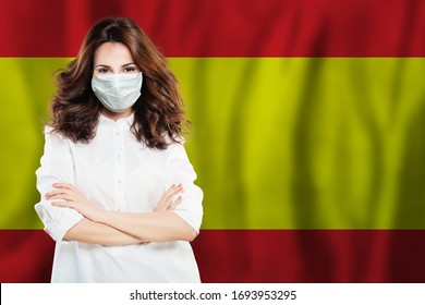 Happy Spanish Doctor Or Nurse In Medical Safety Face Mask On Spainish Flag Background. Flu Epidemic And Virus Protection In Spain Concept