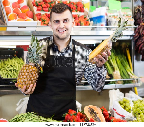 Happy Spanish Male Shopping Assistant Demonstrating Stock Photo Edit Now