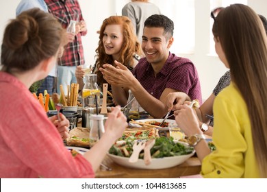 Happy Spanish Man Eating Lunch With Colleagues During A Break In The Company