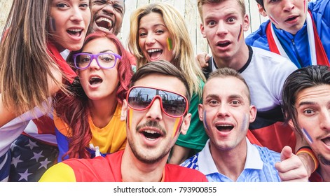 Happy sport supporters having fun during football world game - Young fans at  stadium before soccer match - Friendship,  youth and against racism concept - Main focus on center guys - Powered by Shutterstock