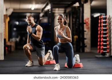 Happy sportspeople in shape are doing lunges in a gym. - Powered by Shutterstock