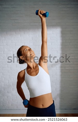 Similar – Image, Stock Photo Happy sportswoman exercising with gymnastic rings in studio