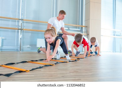 Happy Sporty Children In Gym. Kids Exercises