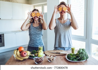 Happy Sporty Couple Is Preparing Healthy Food On Light Kitchen. Healthy Food Concept.