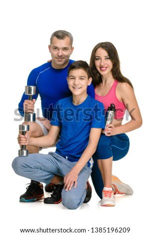 Happy sporty family doing lifting exercise on white background